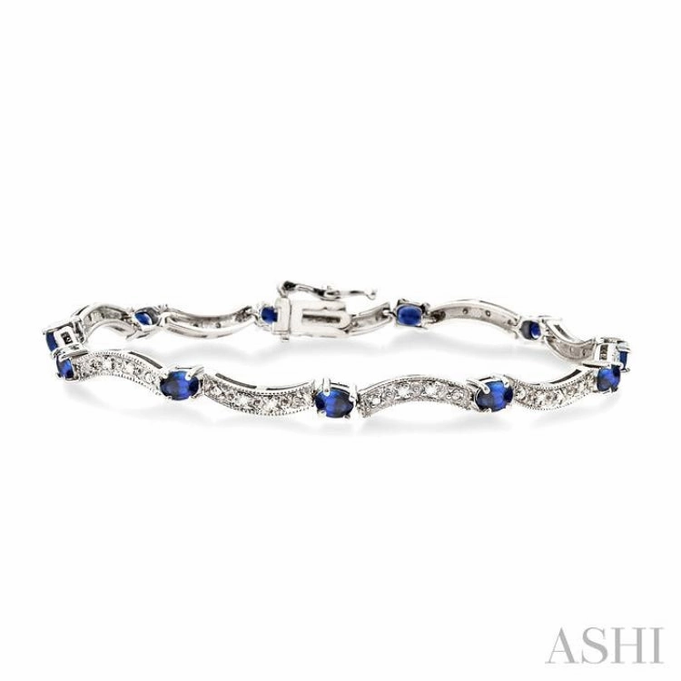 Commendable Combinations 4x3 MM Oval Cut Sapphire and 1/10 ctw Single Cut Diamond Bracelet in 14K White Gold