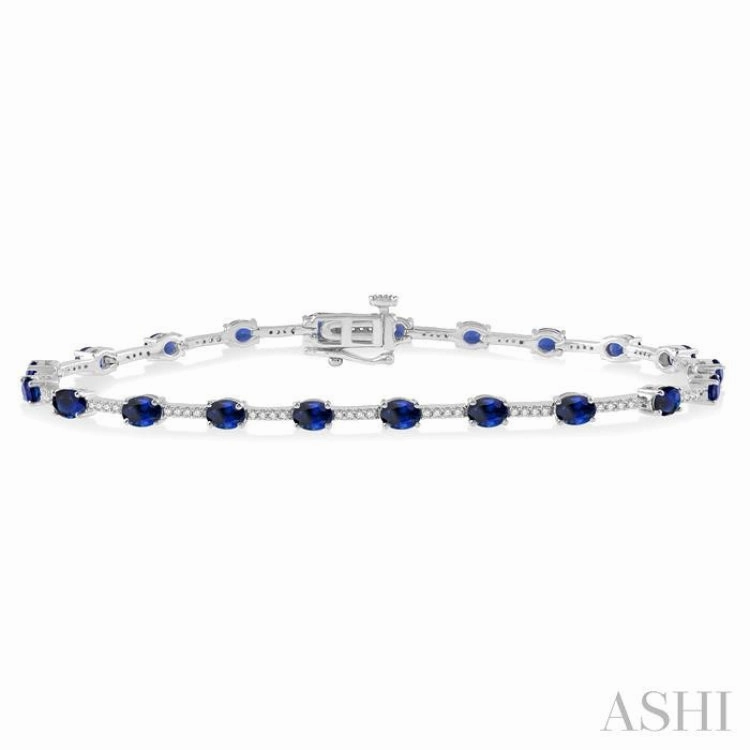 Formal Attire 4x3 MM Oval Cut Sapphire and 1/3 Ctw Round Cut Diamond Precious Bracelet in 10K White Gold