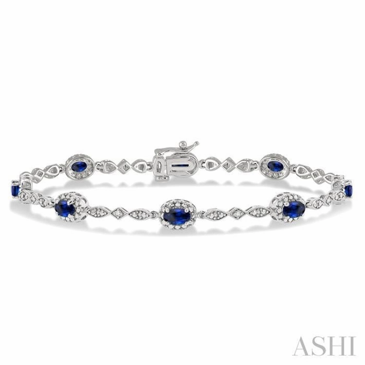 Creative Outlet 5x3 MM Oval Cut Sapphire and 1/20 Ctw Single Cut Diamond Bracelet in 10K White Gold