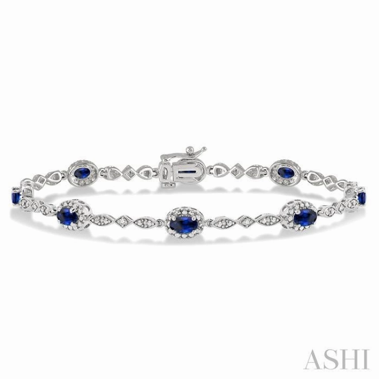 Token Of Love 5x3 MM Oval Cut Sapphire and 1/20 Ctw Single Cut Diamond Bracelet in 14K White Gold