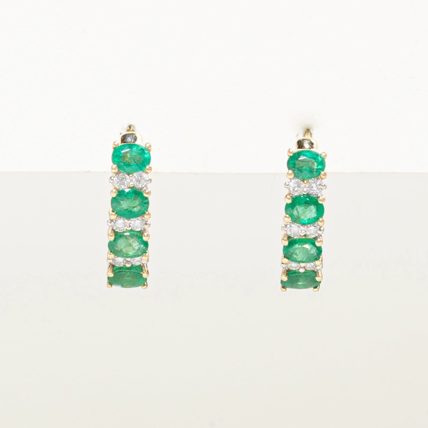 Oval Cut Emerald & Diamond Huggie Earrings | 1.50ctw, 0.18ct Timeless Features